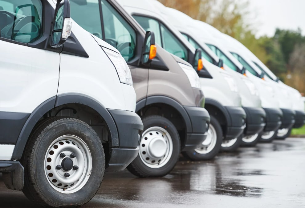 A row of white delivery vans lined up for their routes