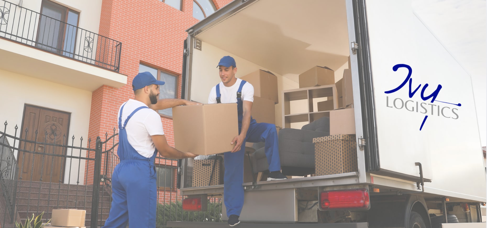 Two Ivy Logistics movers unloading boxes from an Ivy box truck
